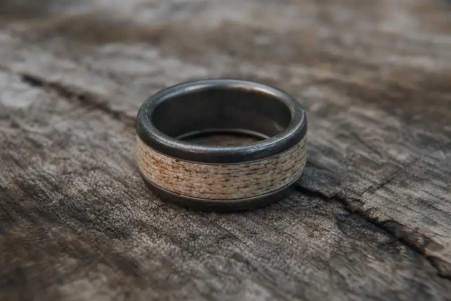A well-worn antler inlay band showing patina