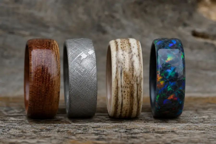 Four inlay bands laid in a row: wood, meteorite, antler, opal